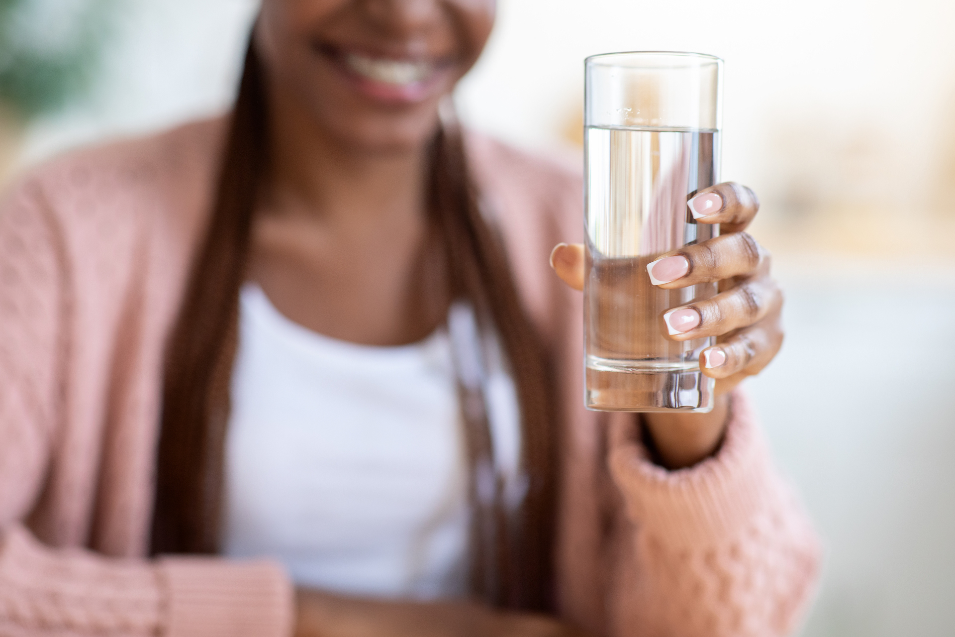 Unrecognizable Black Woman Offering Glass Of Water To Camera, Positive Young African American Female Recommending Healthy Refreshing Drink For Body Hydration, Closeup Shot, Cropped Image